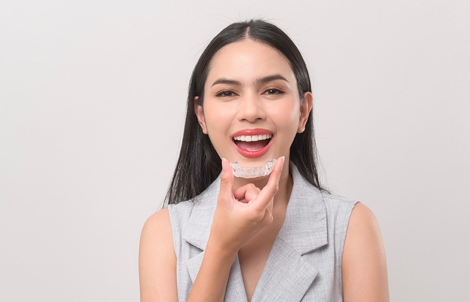 Woman holding Invisalign in Revere